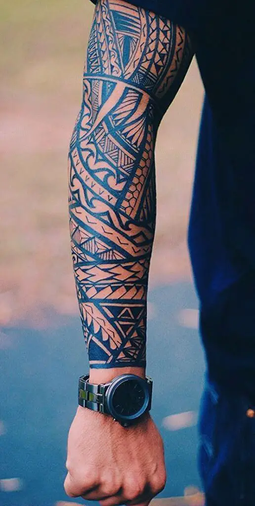 A powerful tribal tattoos for men, featuring intricate black patterns and bold lines