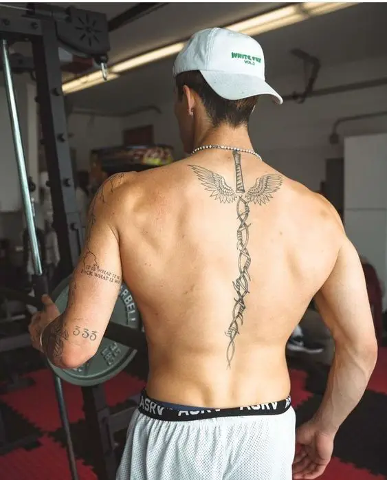 A back tattoos for men looks like a sword with wings