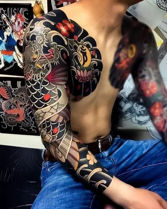 A traditional Japanese full arm tattoo show a dragon style with shapes with vibrant colors symbolizing power and beauty.