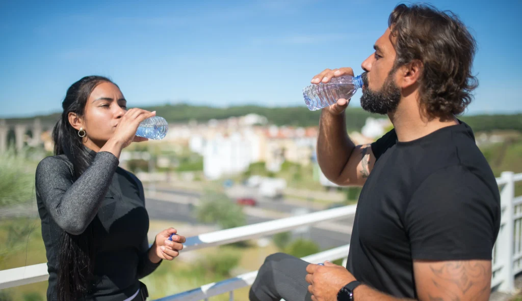 A man and a women drinking water